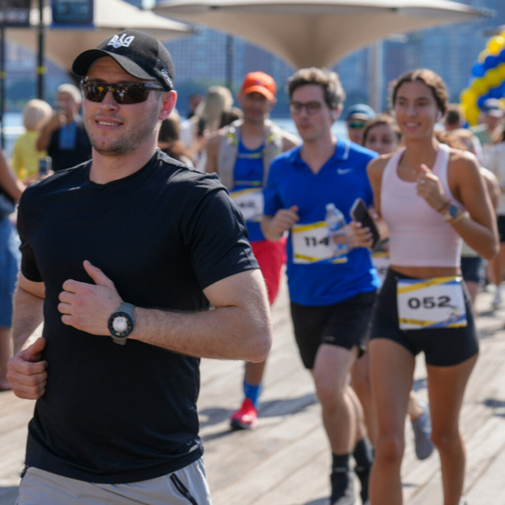 Man and women running a fun run in a city